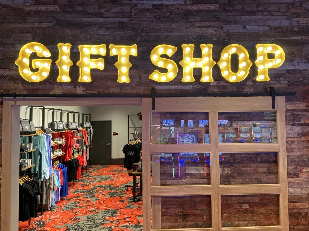 Illuminated marquee-letter sign above a retail storefront