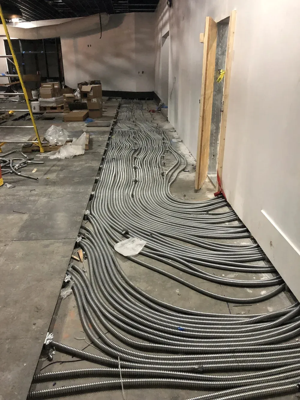 Bundles of feeder cable laid along a corridor during installation