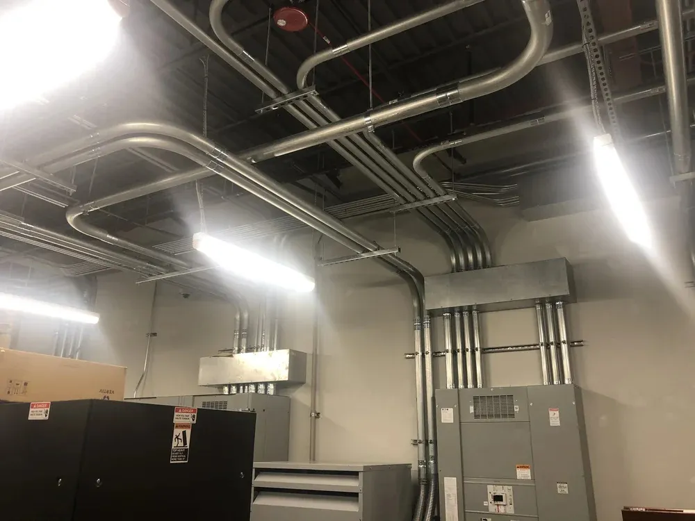 Conduit runs and electrical panels in a commercial electrical room