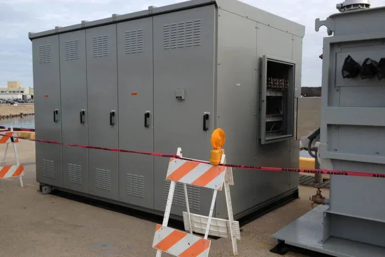 Electrical equipment enclosures secured behind safety barricades