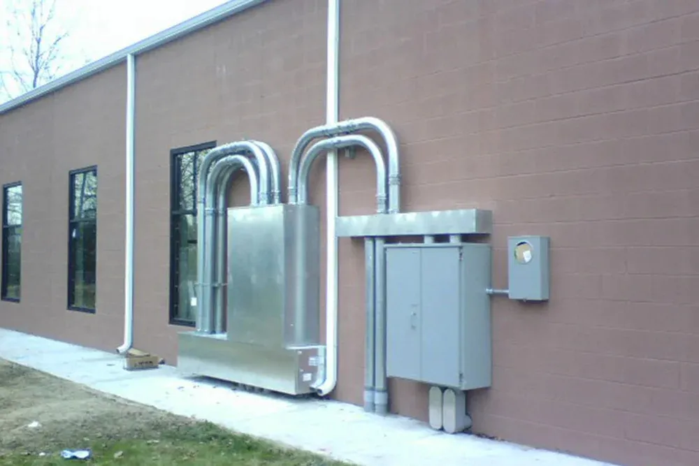 Exterior building wall with service conduit and disconnects