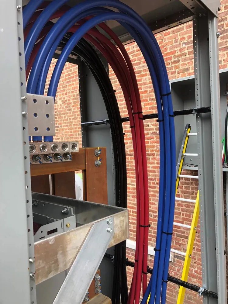 Feeder conductors routed through a steel support frame