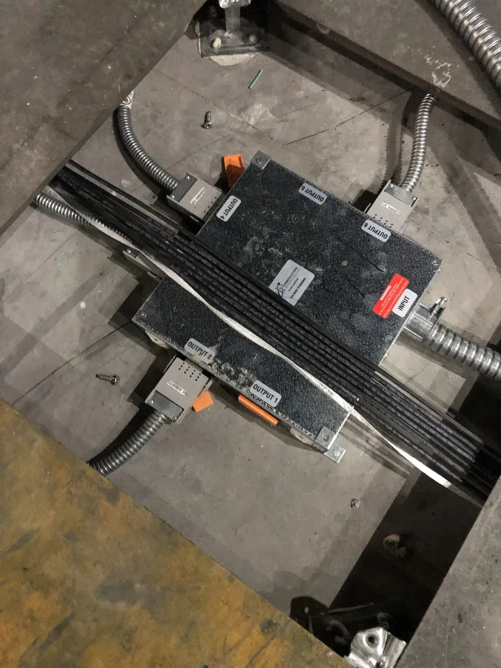 Floor box and in-slab conduit rough-in on a concrete floor